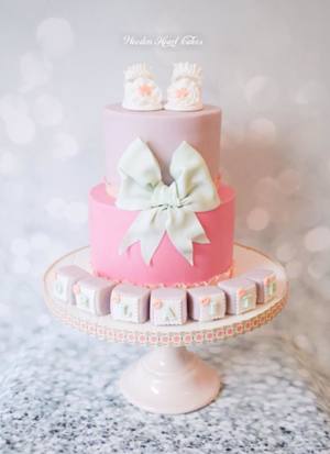 Girls christening cake with edible baby shoes 