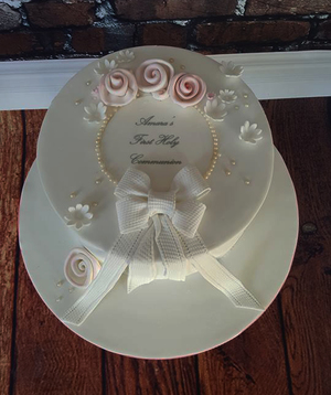 Amara - Roses and Bows Communion Cake.  Starts at €100 