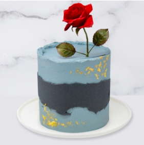The Abstract, Rose & Gold Leaf Cake is a buttercream iced cake. The single tier is 6″ deep and 2 tier options are 10″ deep. You can choose to have either a handmade sugar rose,  which is edible, or a fresh rose.  A name plaque can be added to the front of the cake.