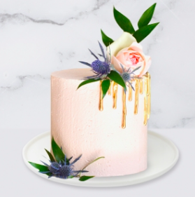 The Drip & Flower Cake is a buttercream iced cake. The single tier is 6″ deep and 2 tier options are 10″ deep. A name plaque can be added to the front of the cake.  The hand painted gold drip is edible. The flowers and greenery are fresh and not edible. Note: The colour and size of the flowers and greenery may vary due to availability.