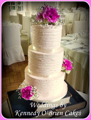 Soft blush pink buttercream and fresh flowers wedding cake