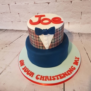 An amazing two tier christening cake made with tartan print to match the little boys outfit