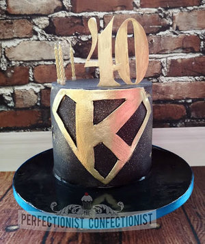 Superman  k  logo  birthday cake  40th  malahide  kinsealy  dublin  black  gold  man  celebration  novelty  chocolate biscuit cake  %281%29