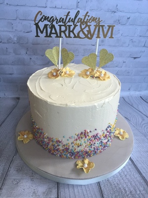 A Vanilla Sponge Engagement Cake with Glitter Topper and decorated with miniture pearlised balls