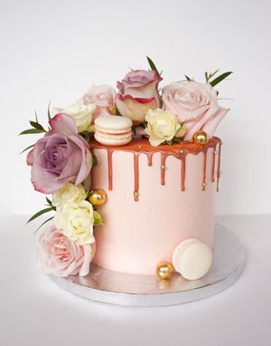 Buttercream cake with fresh flowers and macarons