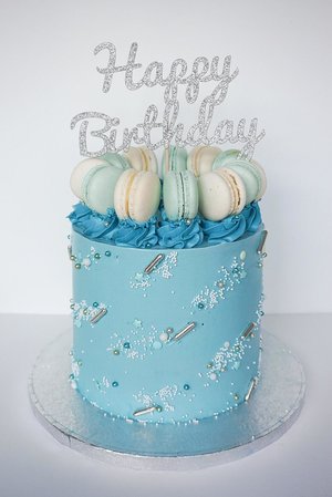 Buttercream cake with macarons and sprinkles