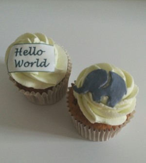 Christening cupcakes to match 'Hello World' baby shower cake 